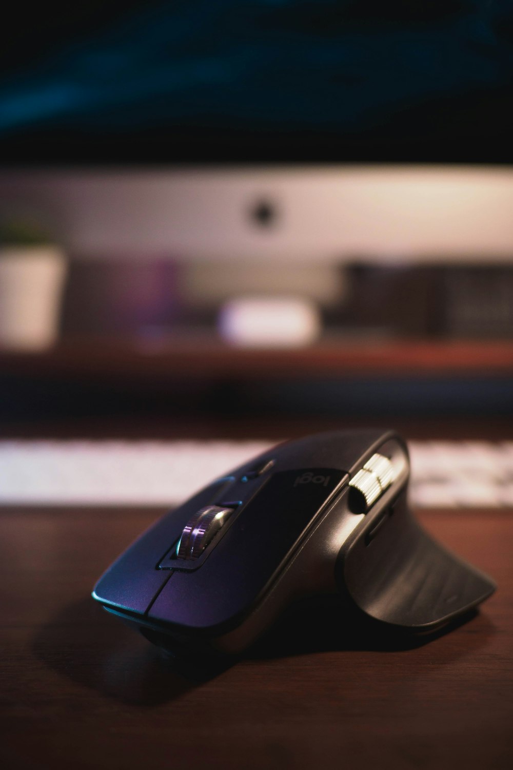 black cordless computer mouse on brown wooden table