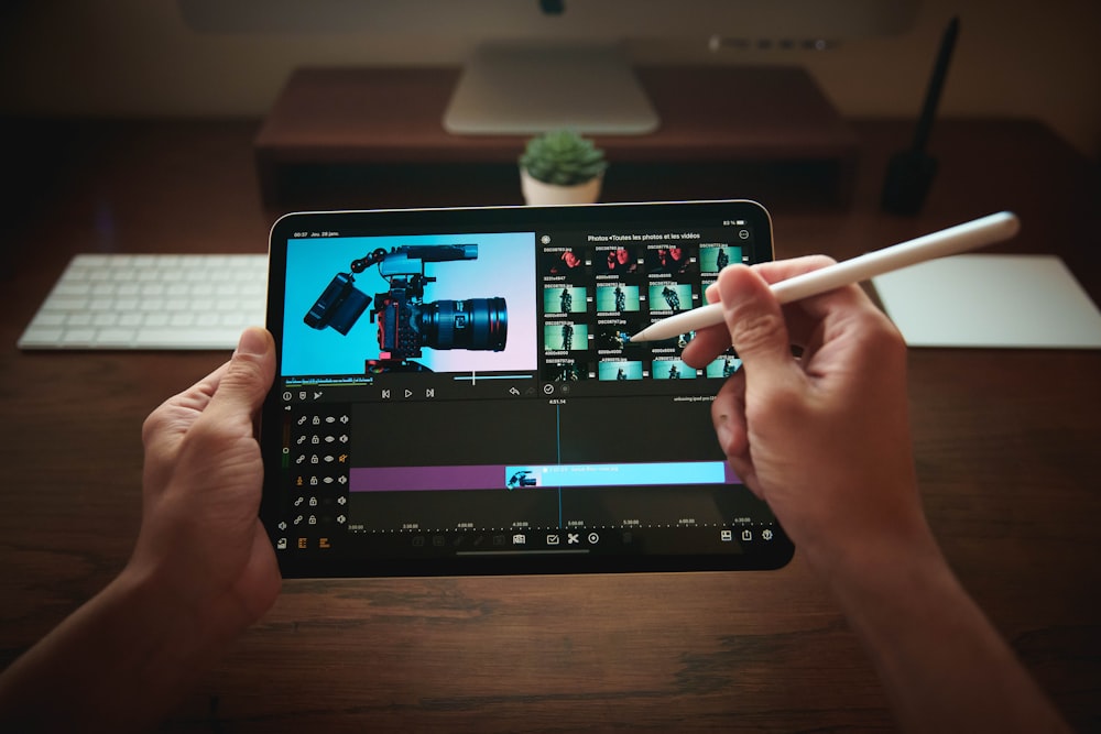 person holding black tablet computer