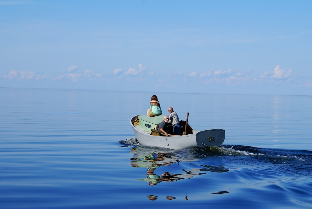 2 person riding on yellow and black kayak on blue sea during daytime