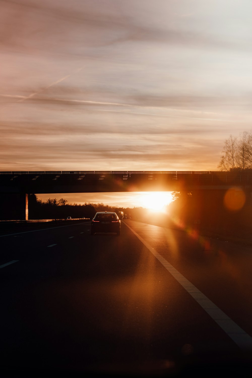 black car on road during sunset