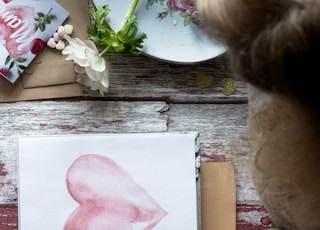 pink heart painting on brown wooden table