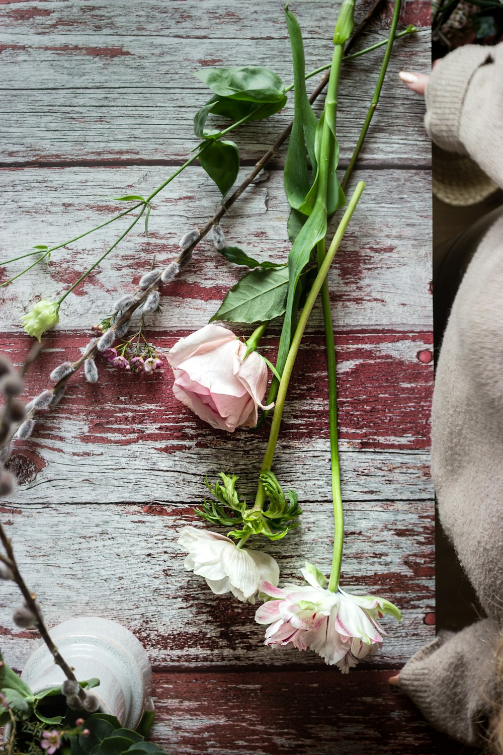 white and pink flowers on brown wooden surface