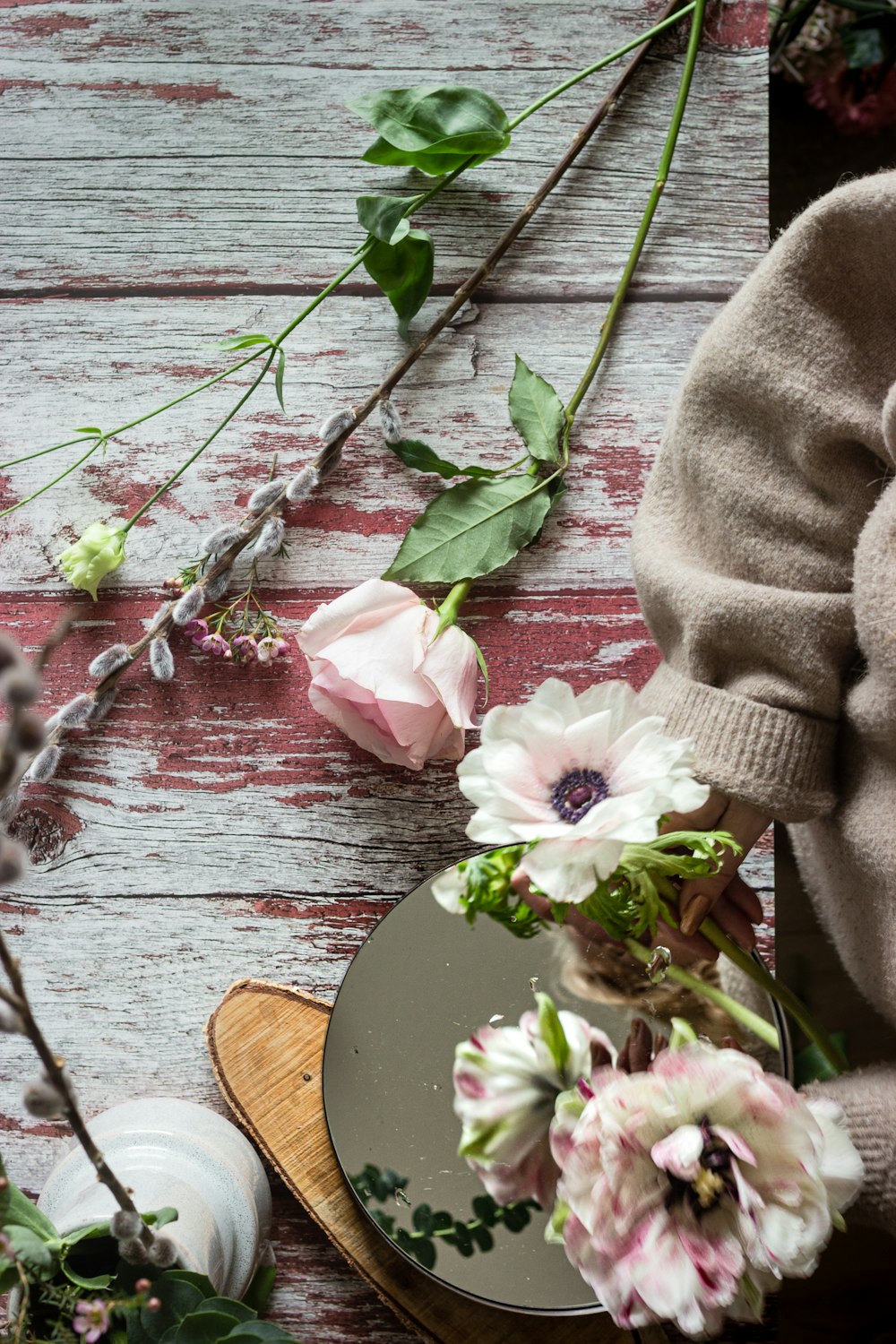 pink and white flower on brown wooden table