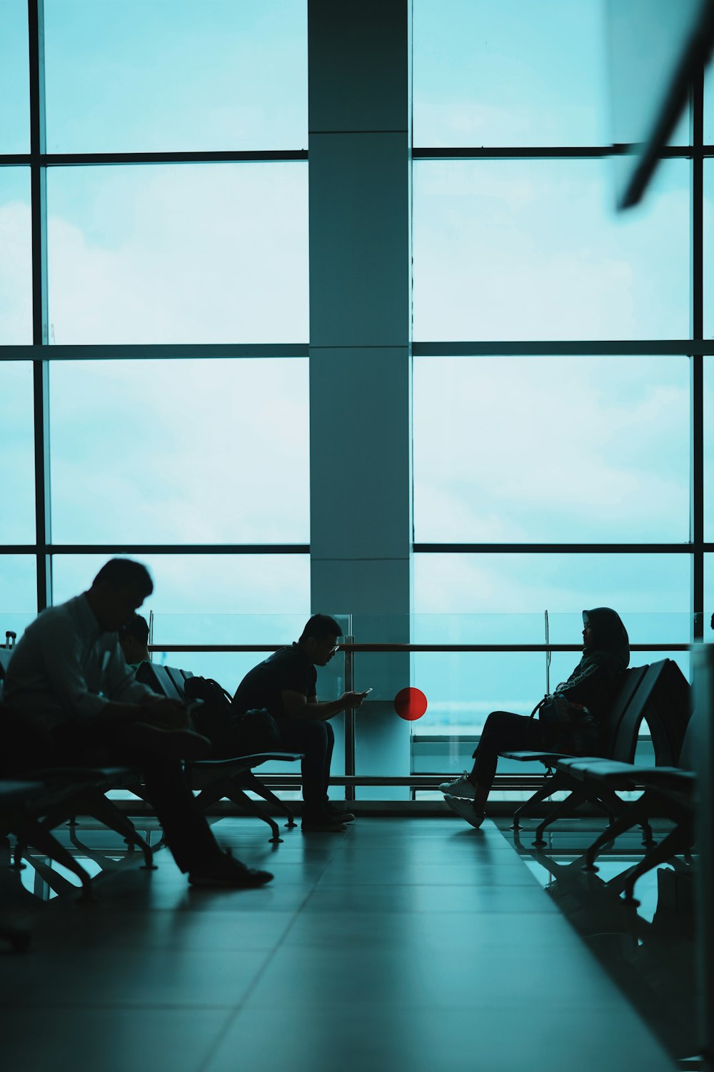 people sitting on chair near window