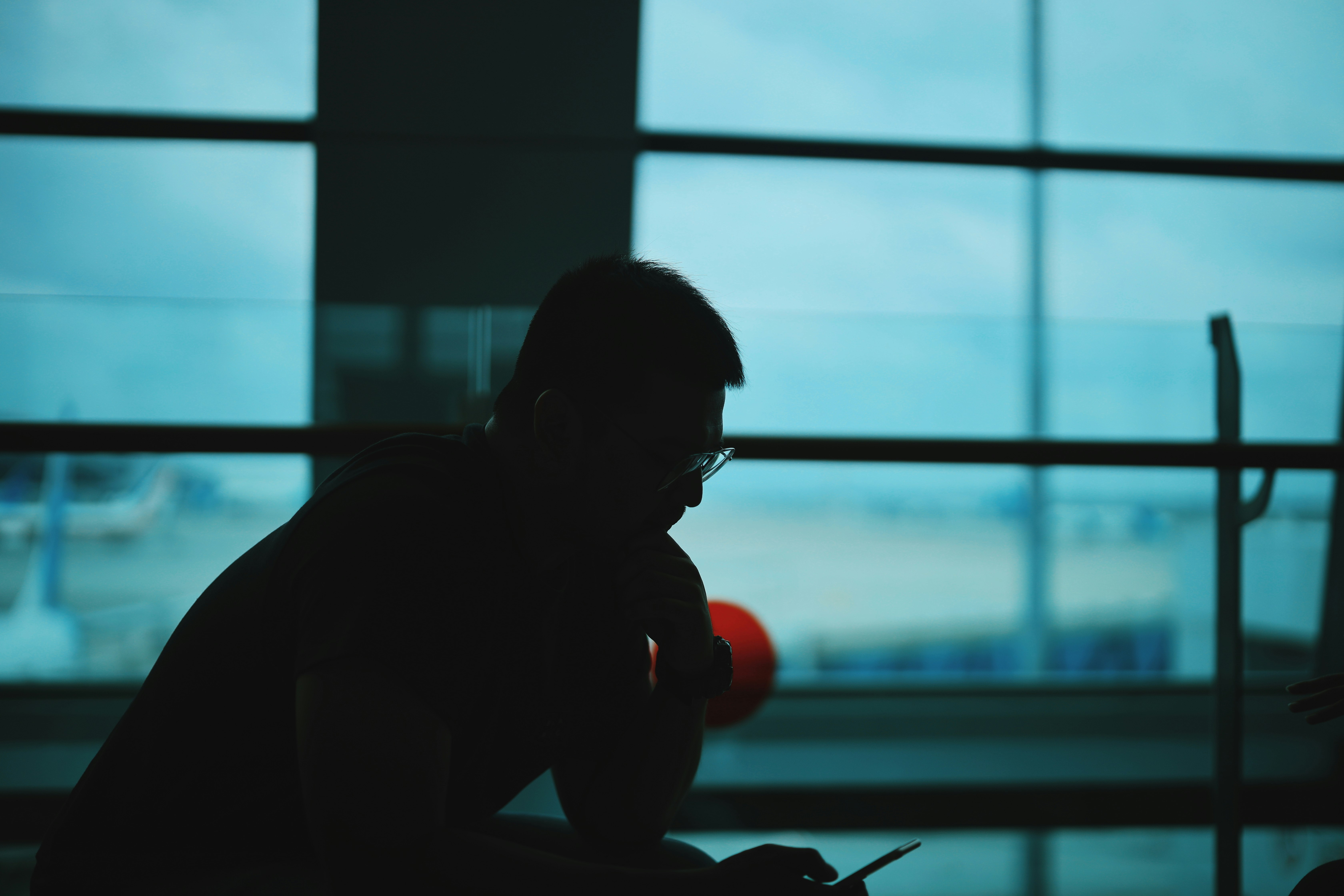 silhouette of man sitting on chair