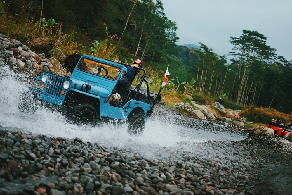 woman in black jeep wrangler on river during daytime