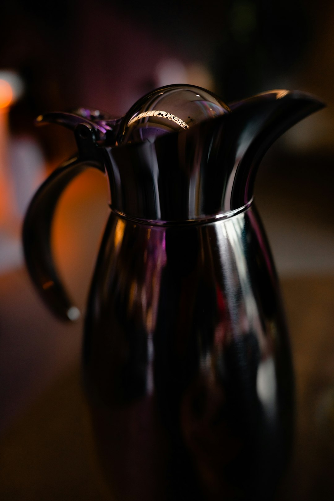 black ceramic pitcher on brown wooden table