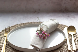 Close-up of elegant bagasse plates stacked neatly on a warm beige linen cloth.
