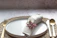 A cozy summer table setting with linen napkins and handmade ceramic plates.
