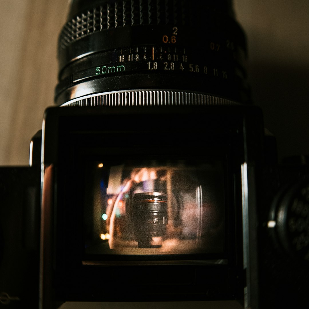 black dslr camera on brown wooden table