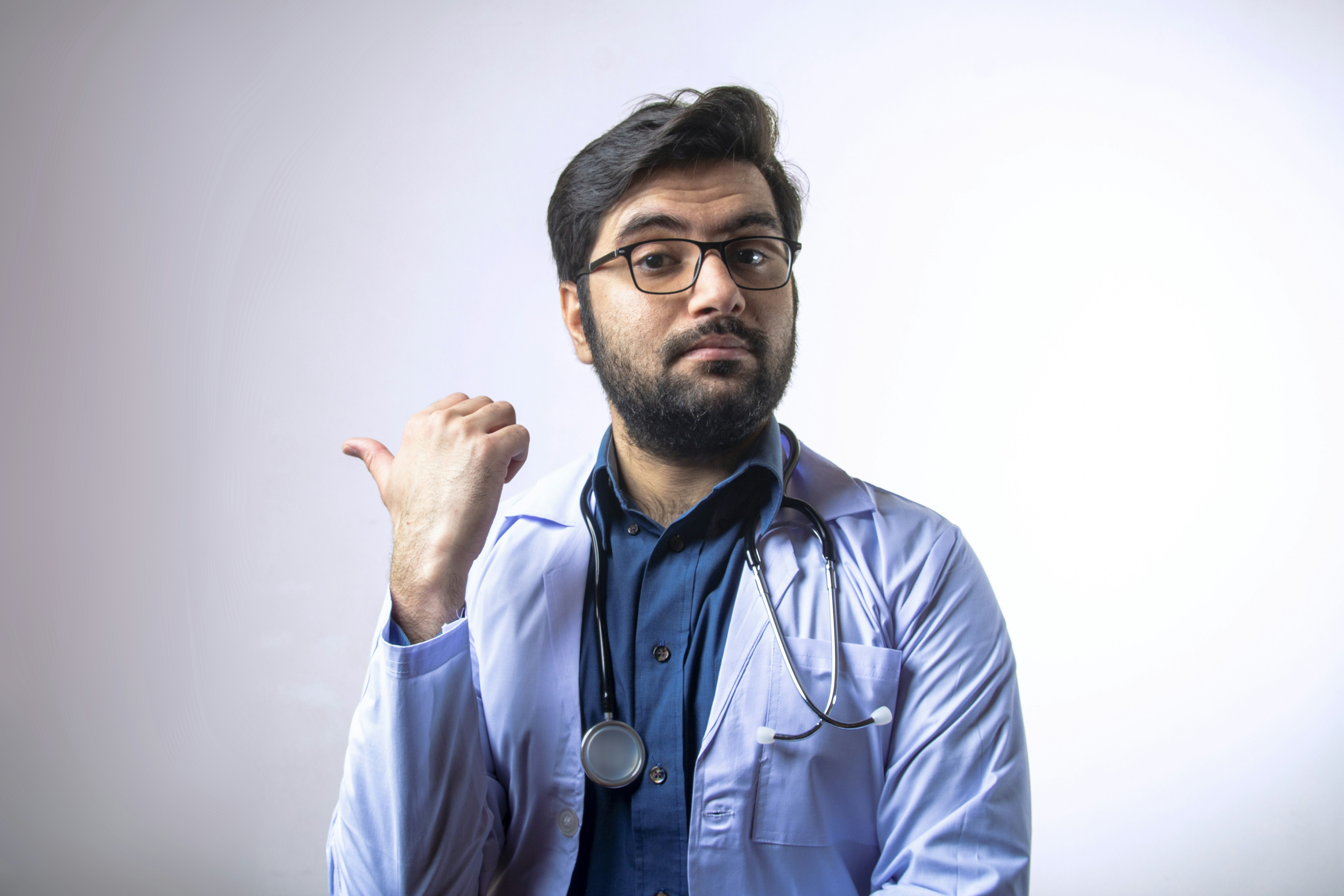 man in blue dress shirt wearing black framed eyeglasses