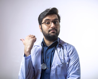 man in blue dress shirt wearing black framed eyeglasses