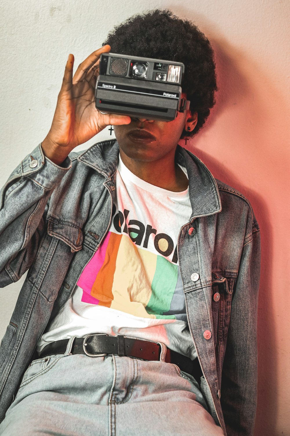 man in blue denim button up jacket holding black and gray camera