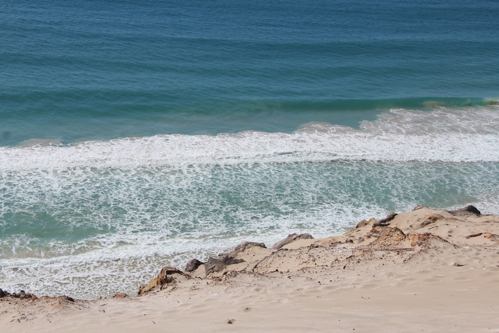 brown rocks on seashore during daytime