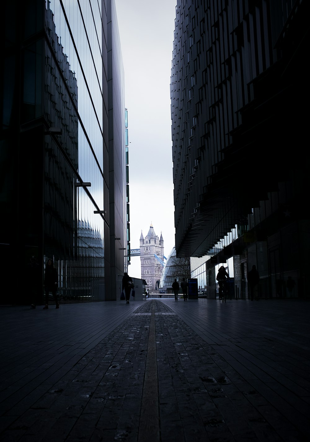 people walking on street between high rise buildings during daytime