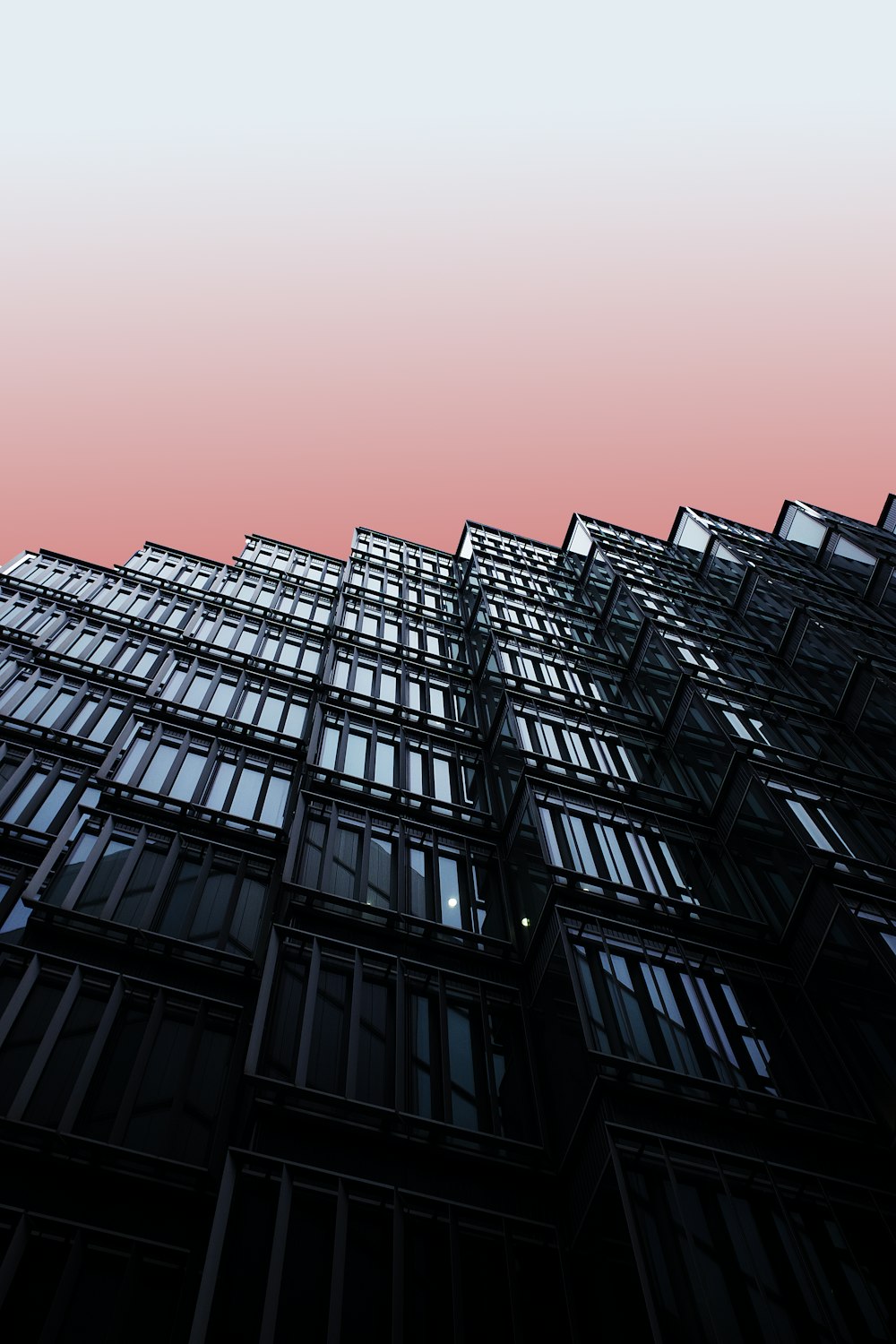 black and gray building under orange sky