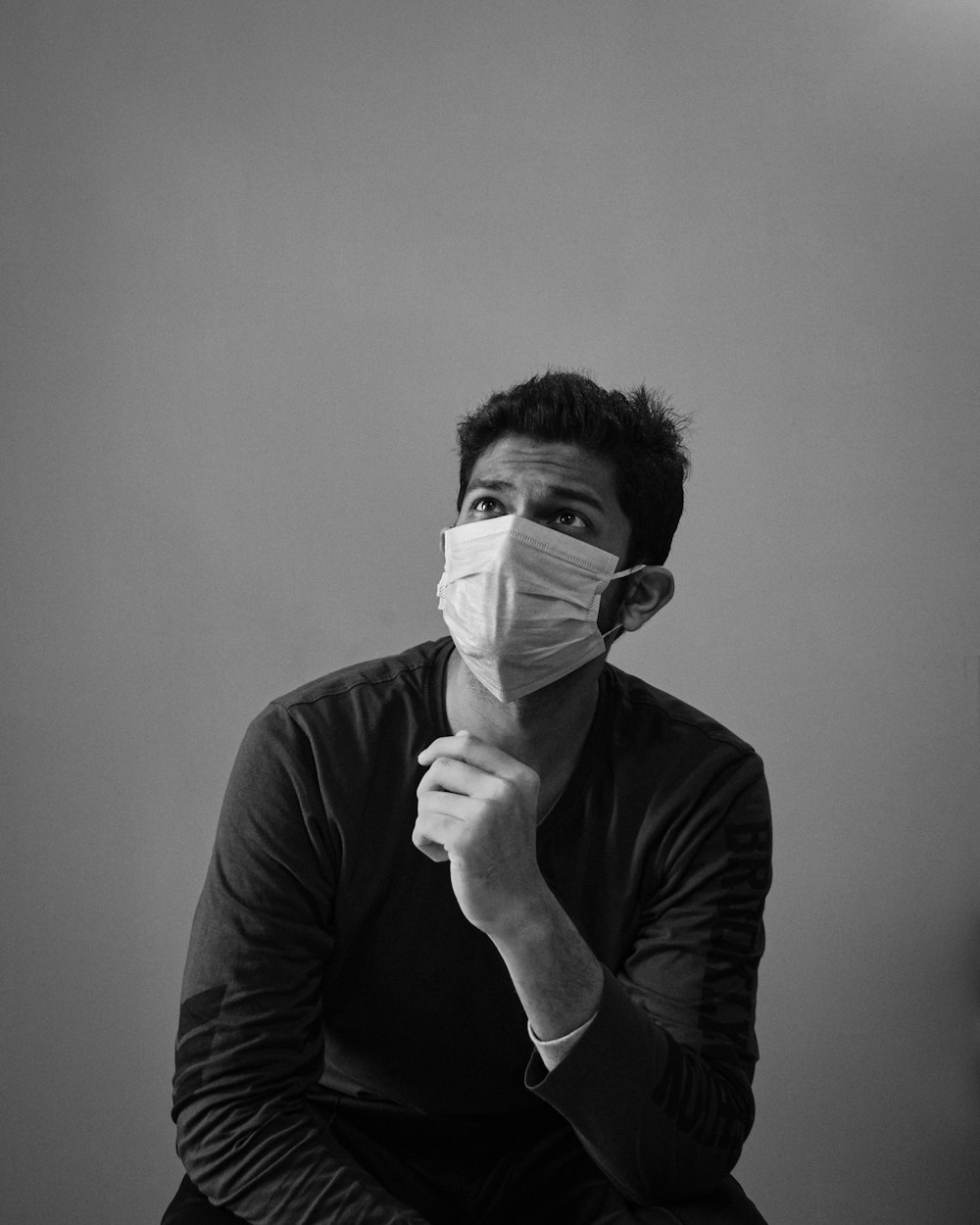 man in black long sleeve shirt holding white paper