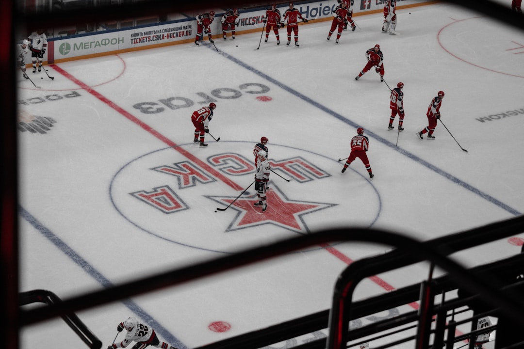 people playing ice hockey on ice field