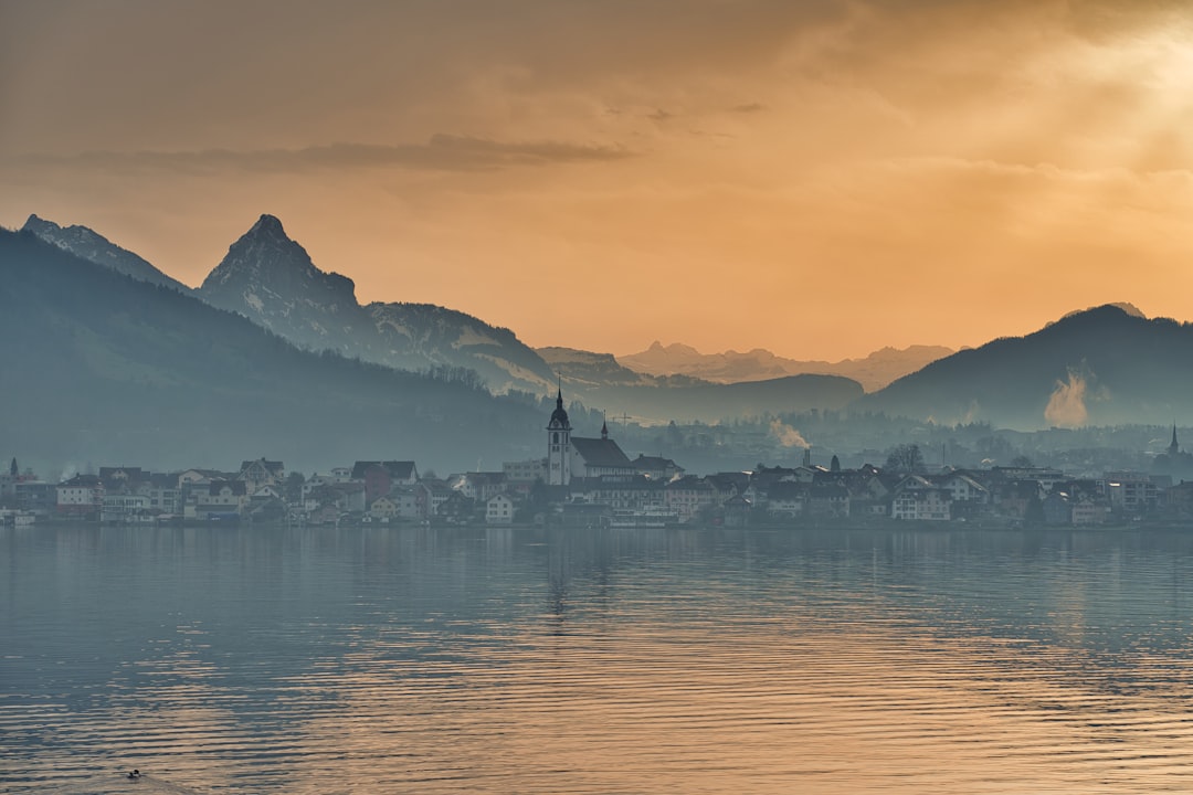 body of water near mountain during daytime