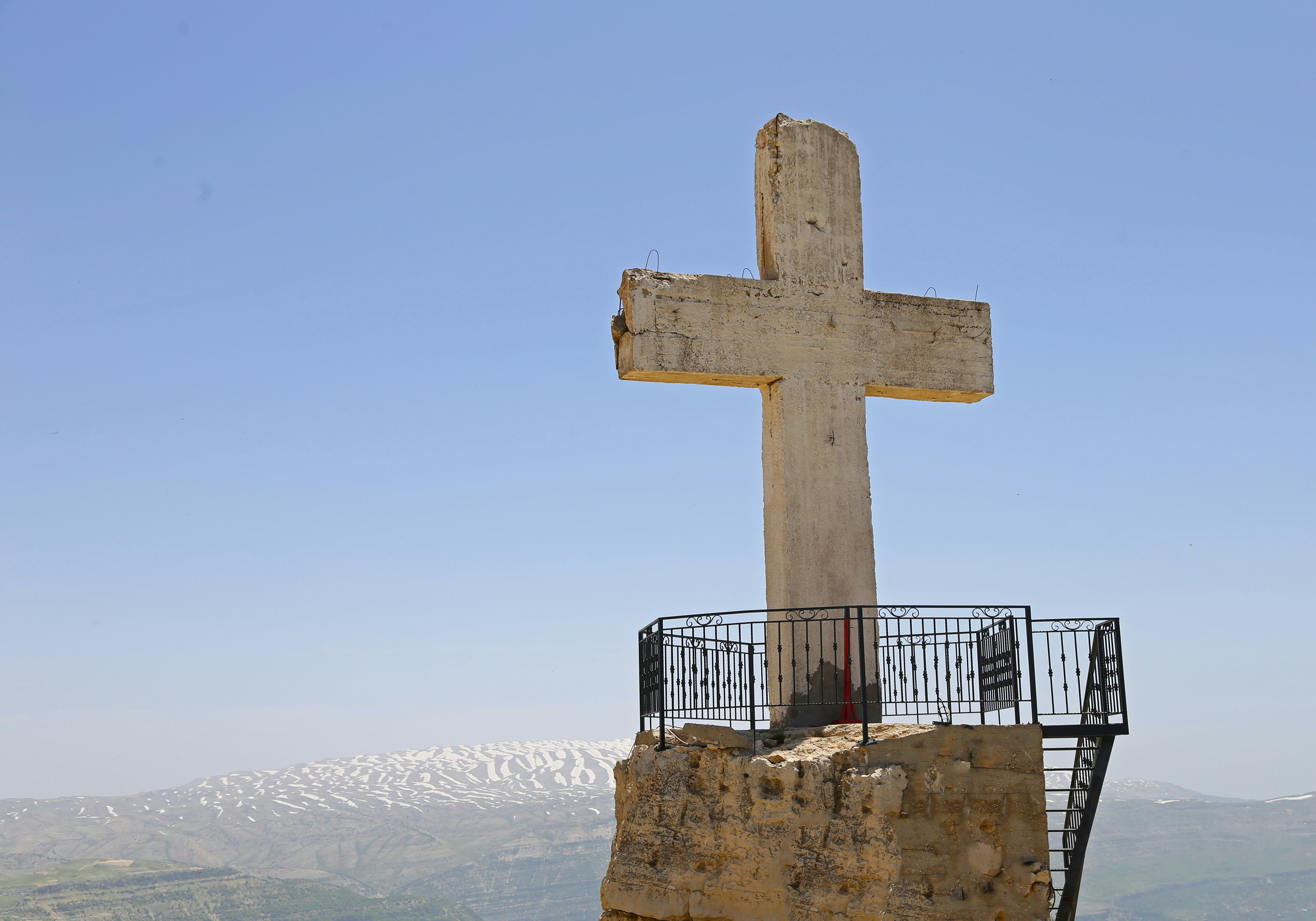 brown cross on brown rock formation during daytime