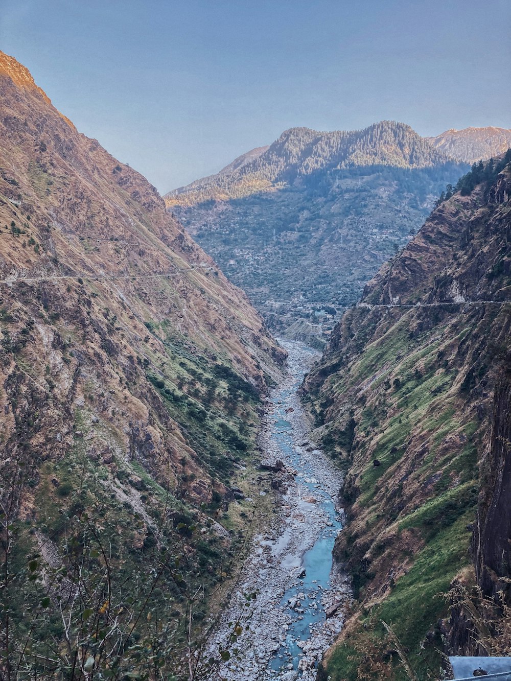 river between mountains during daytime