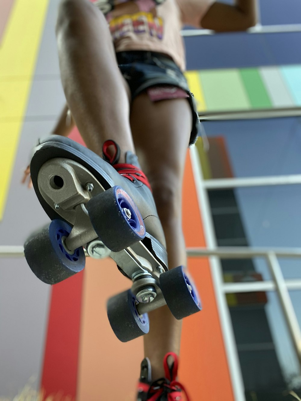 person in black and red shorts holding black and gray dumbbell