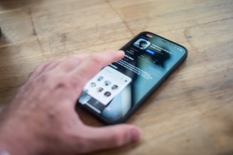 person holding black iphone 4