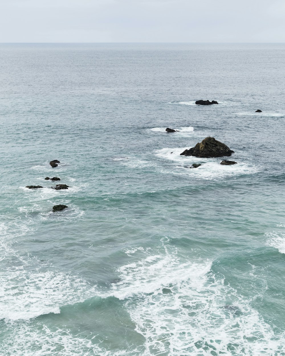 brown rock formation on sea during daytime