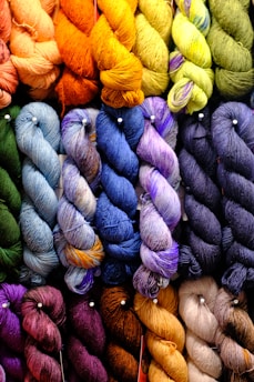 Close-up of colorful knitted yarn swatches arranged in a cozy pattern.