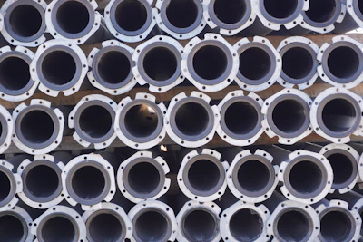 Stacks of copper cathode scrap ready for shipment at a busy warehouse.