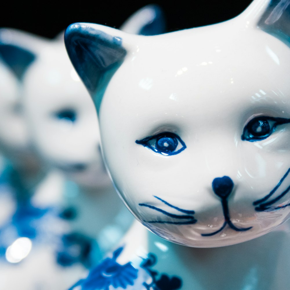 white and black cat figurine