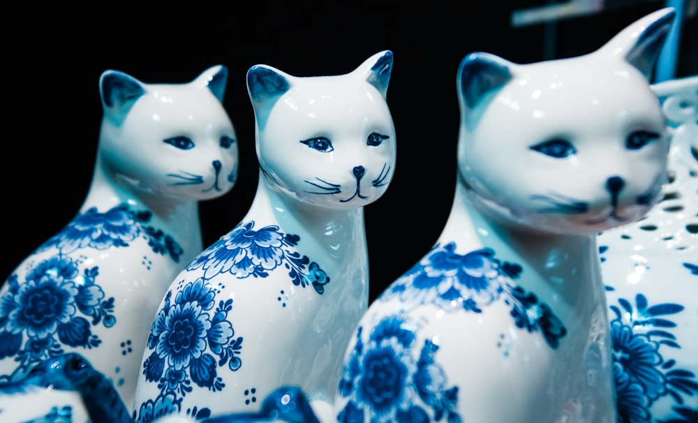white and blue floral ceramic cat figurines