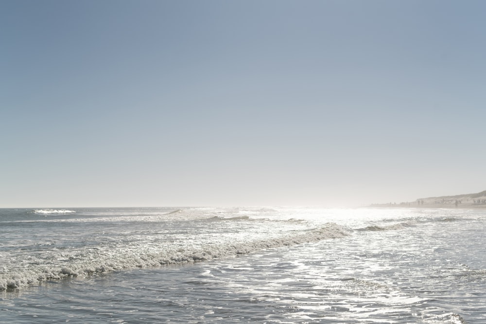 ocean waves crashing on shore during daytime