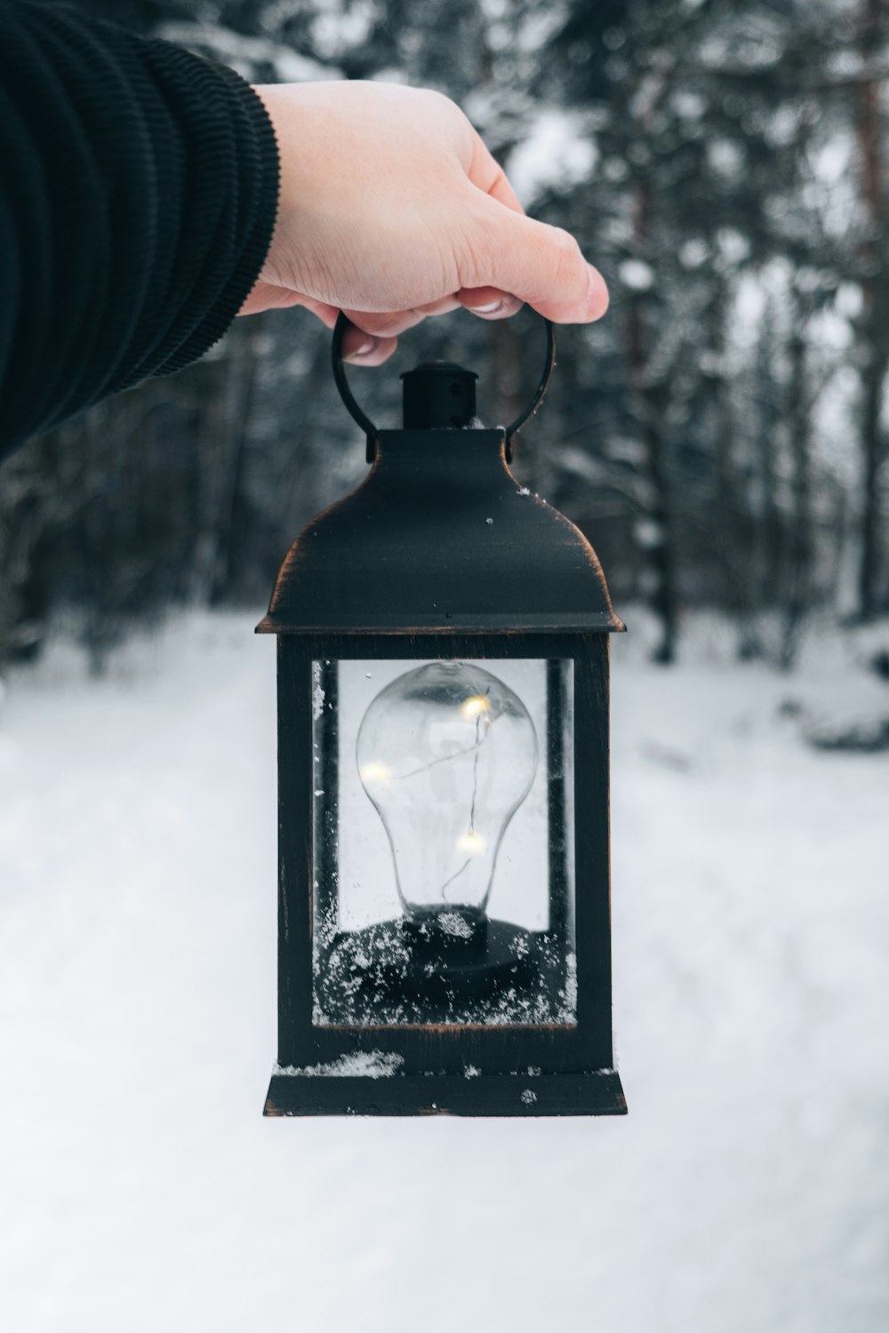 person holding black lantern during daytime