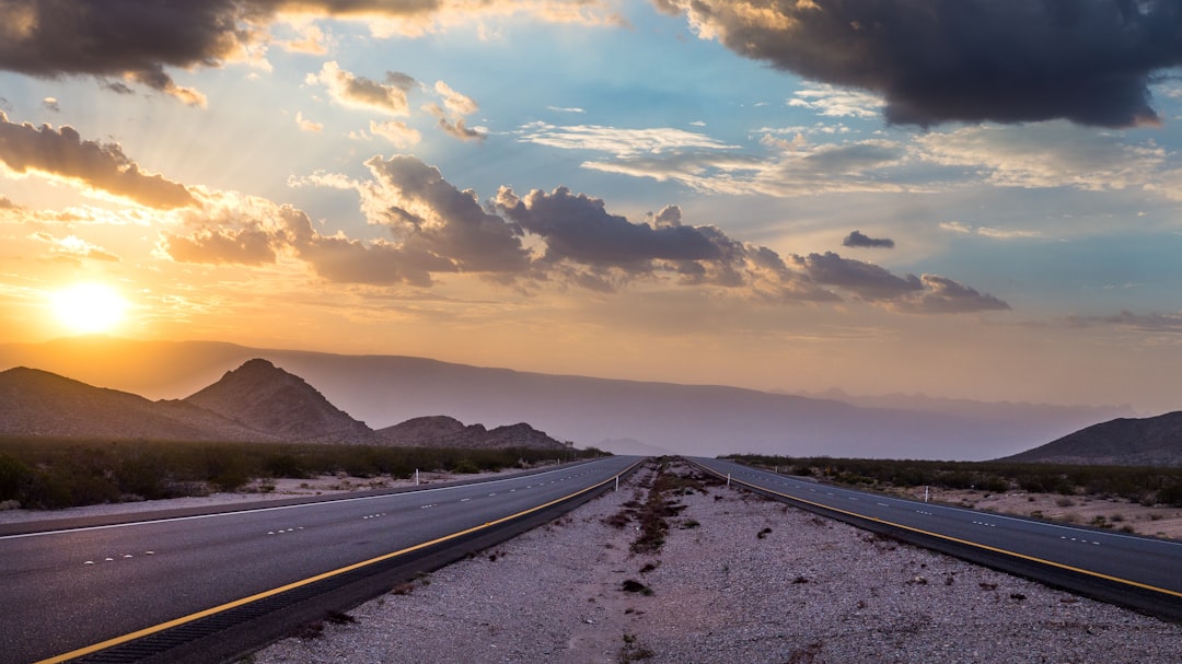 black asphalt road under cloudy sky during daytime