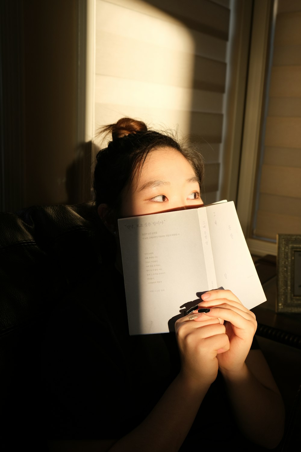 woman holding white printer paper