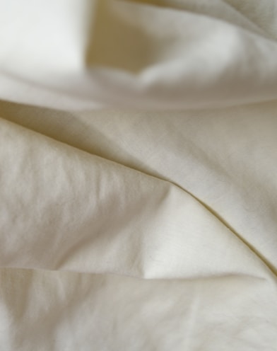 white textile on brown wooden table