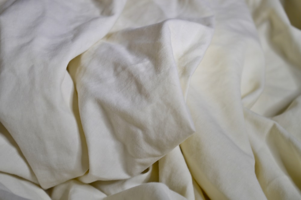 white textile on brown wooden table