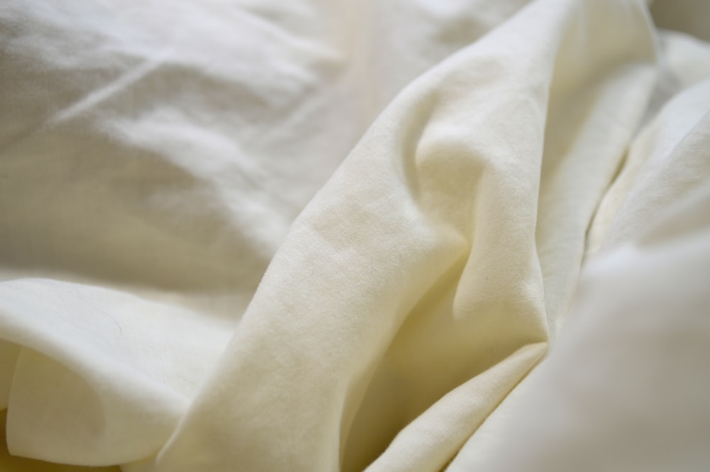 white textile on brown wooden table