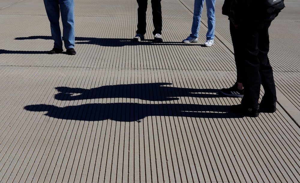 people walking on gray pavement during daytime