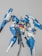 A highly detailed model of a futuristic blue and white robot with various angular components and weaponry. The robot has a sleek design with red, yellow, and gray accents, featuring large appendages that suggest advanced technology and flight capability.