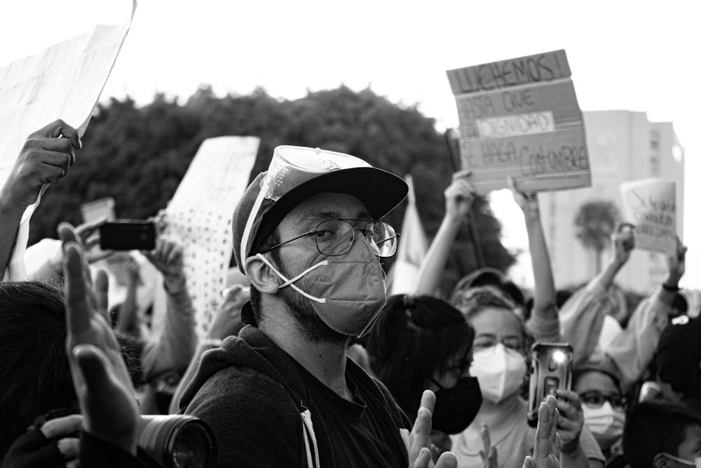 grayscale photo of man wearing hat and eyeglasses