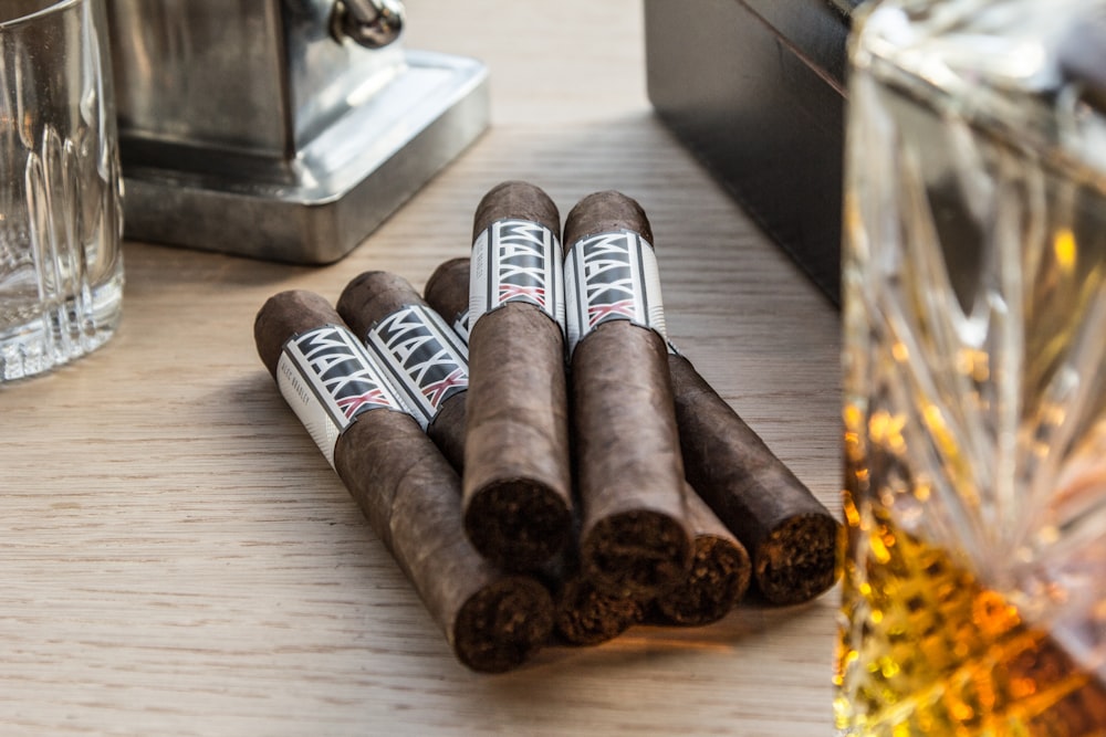 a group of cigars sitting on top of a wooden table