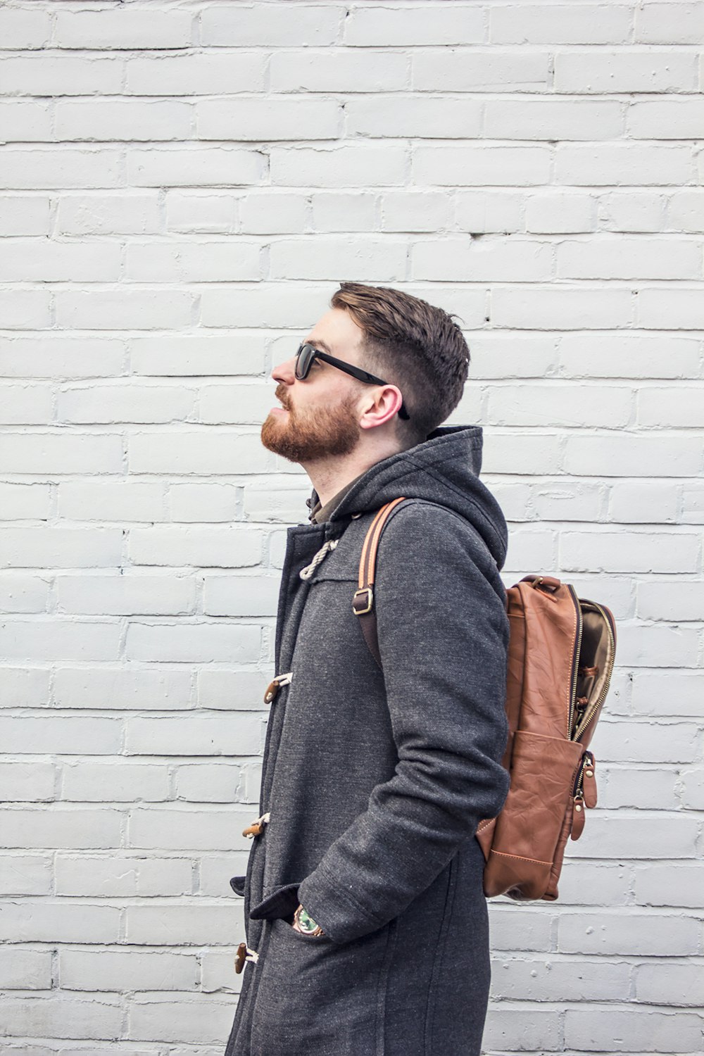 man in black jacket wearing black framed eyeglasses