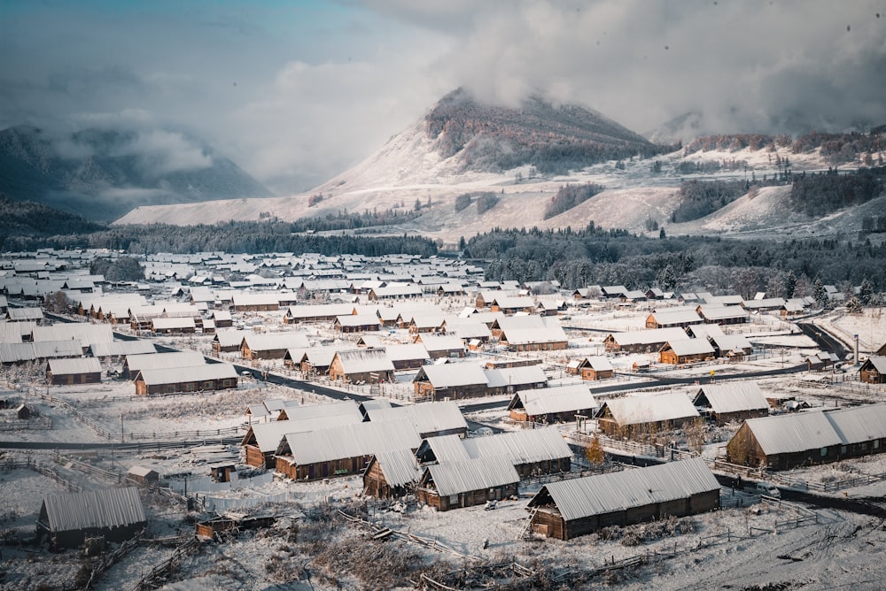 a snow covered town with a mountain in the background