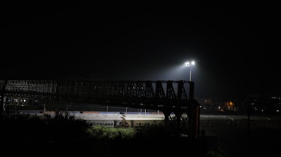 Wide view of a well-lit industrial area at night using AC solar flood lights.
