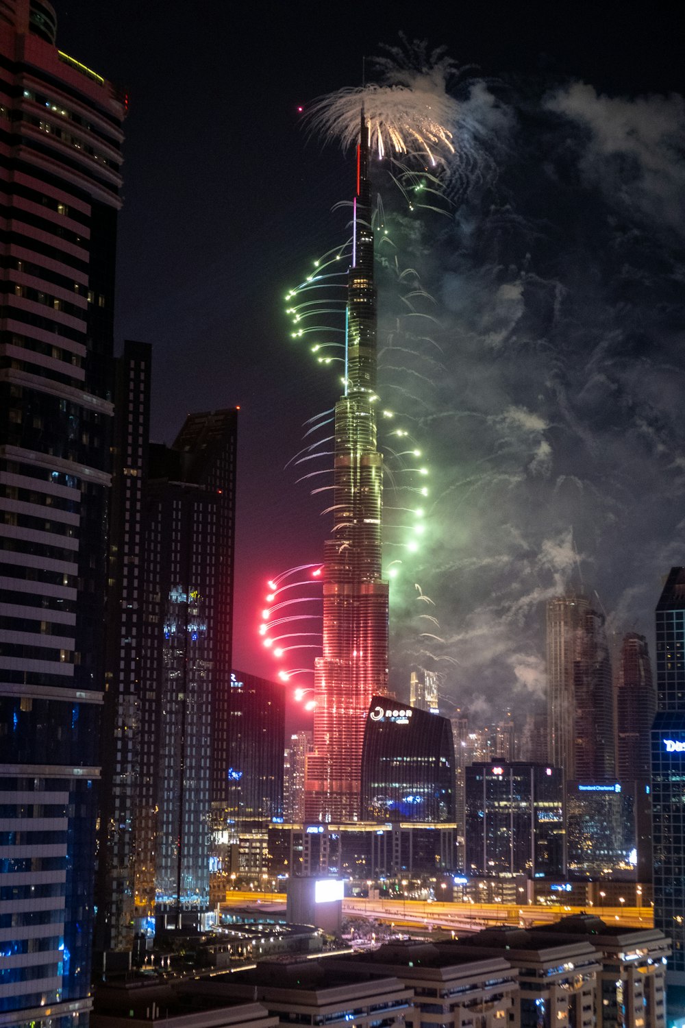 high rise buildings with lights turned on during night time