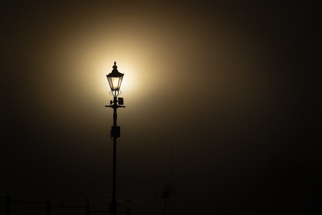 black metal lamp post turned on in room