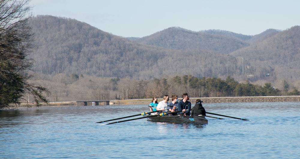 people riding on boat on lake during daytime