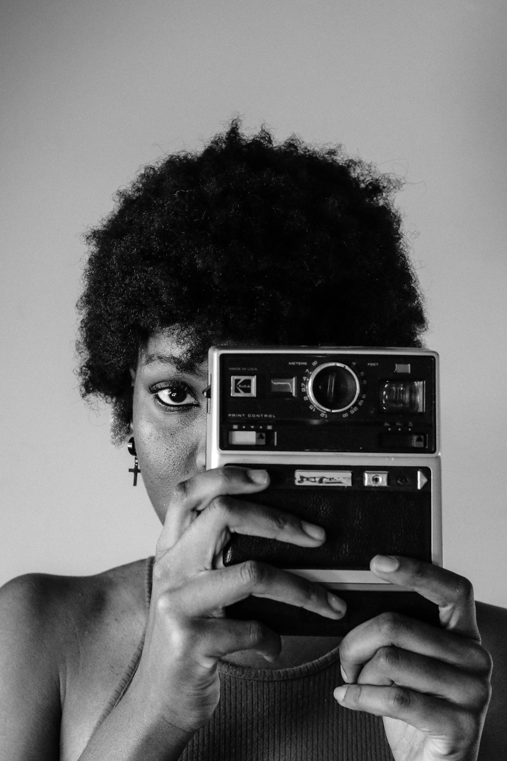 grayscale photo of man holding vintage camera